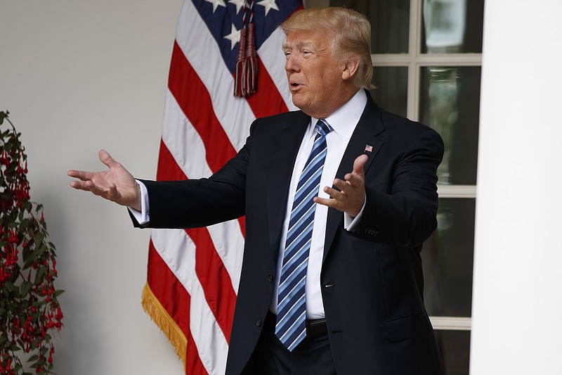 President Donald Trump talks with reporters as he walks to the Oval Office of the White House in Washington, Tuesday, May 2, 2017. President Donald Trump says the nation "needs a good `shutdown' in September" to fix a "mess" in the Senate, saying on Twitter that the country needs to "either elect more Republican Senators in 2018 or change the rules now to 51 (percent)," suggesting more rules changes ahead in the Senate. (AP Photo/Evan Vucci)