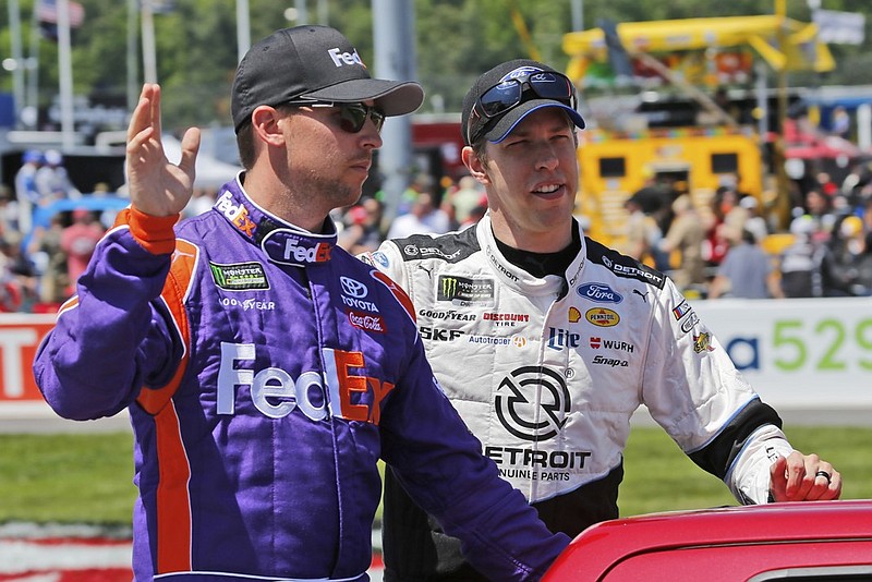 Brad Keselowski, right, and Denny Hamlin wave to the crowd during driver introductions before this past Sunday's race at Richmond International Raceway.