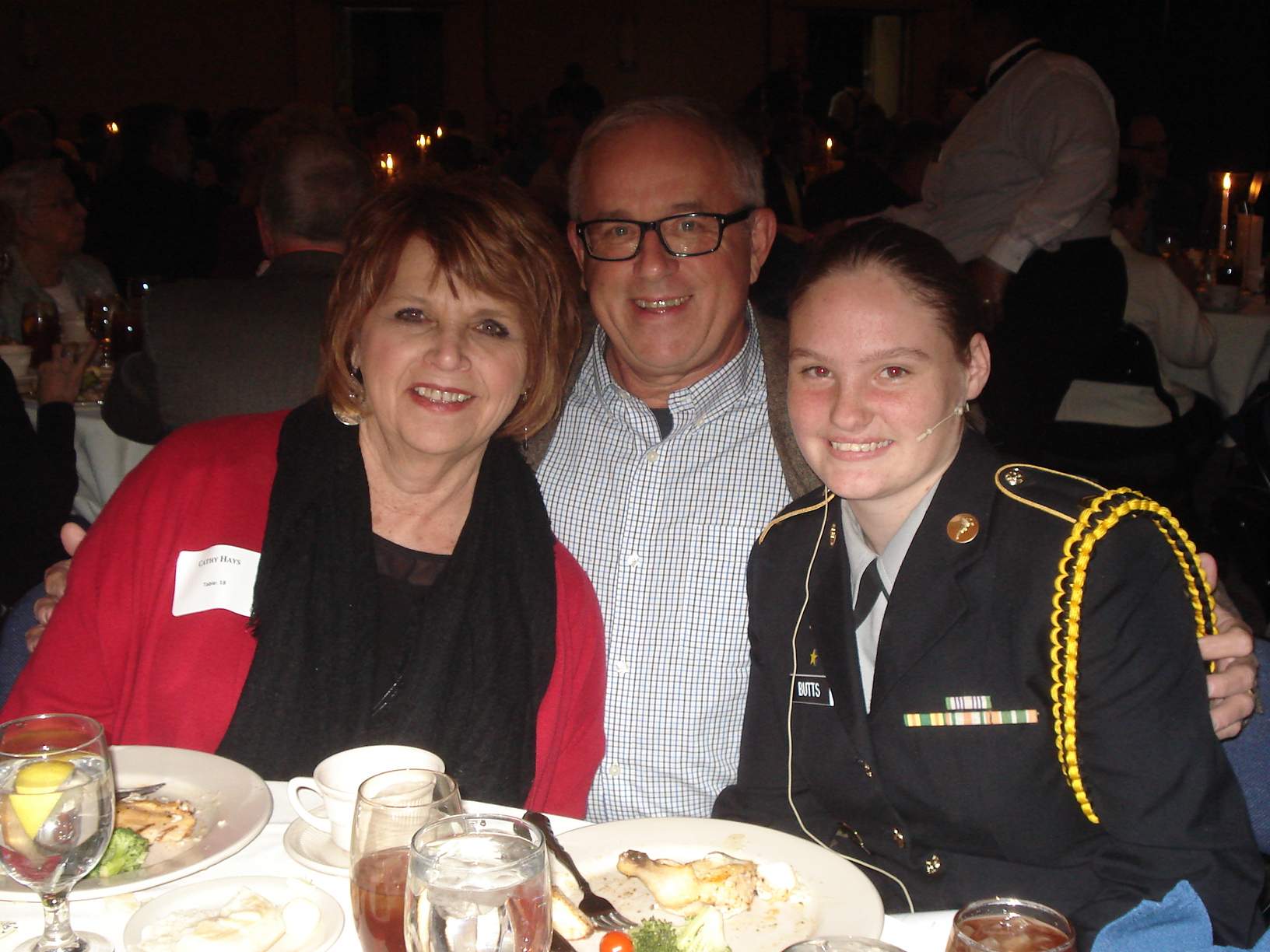 Cathy and Terry Hays, from left, with Ashley Butts, Junior ROTC cadet speaker.