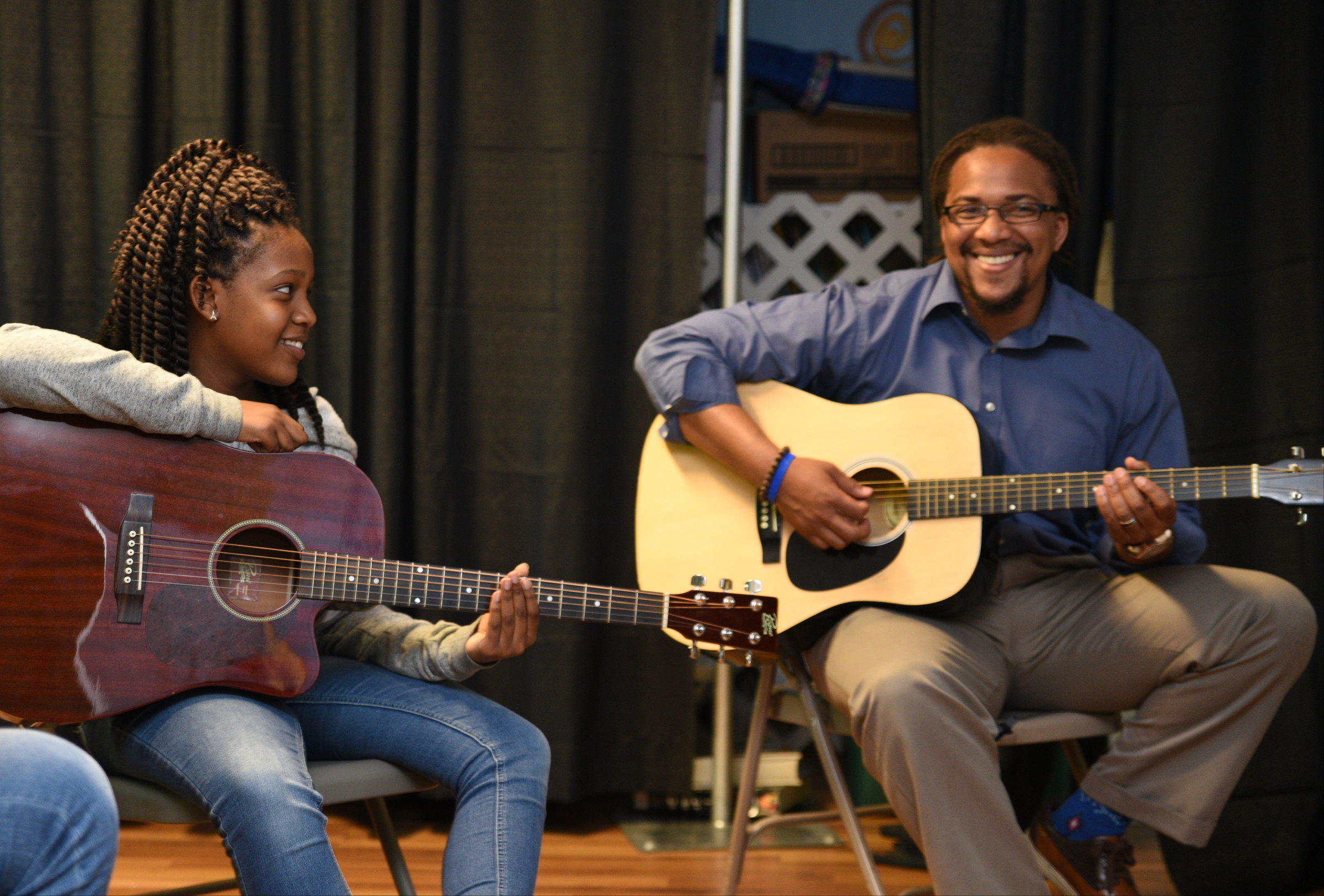 David Yancey, right, teaches a music-based physics lesson as Amari Sims listens Wednesday, April 26, 2017 at Temple of Faith Deliverance Church.