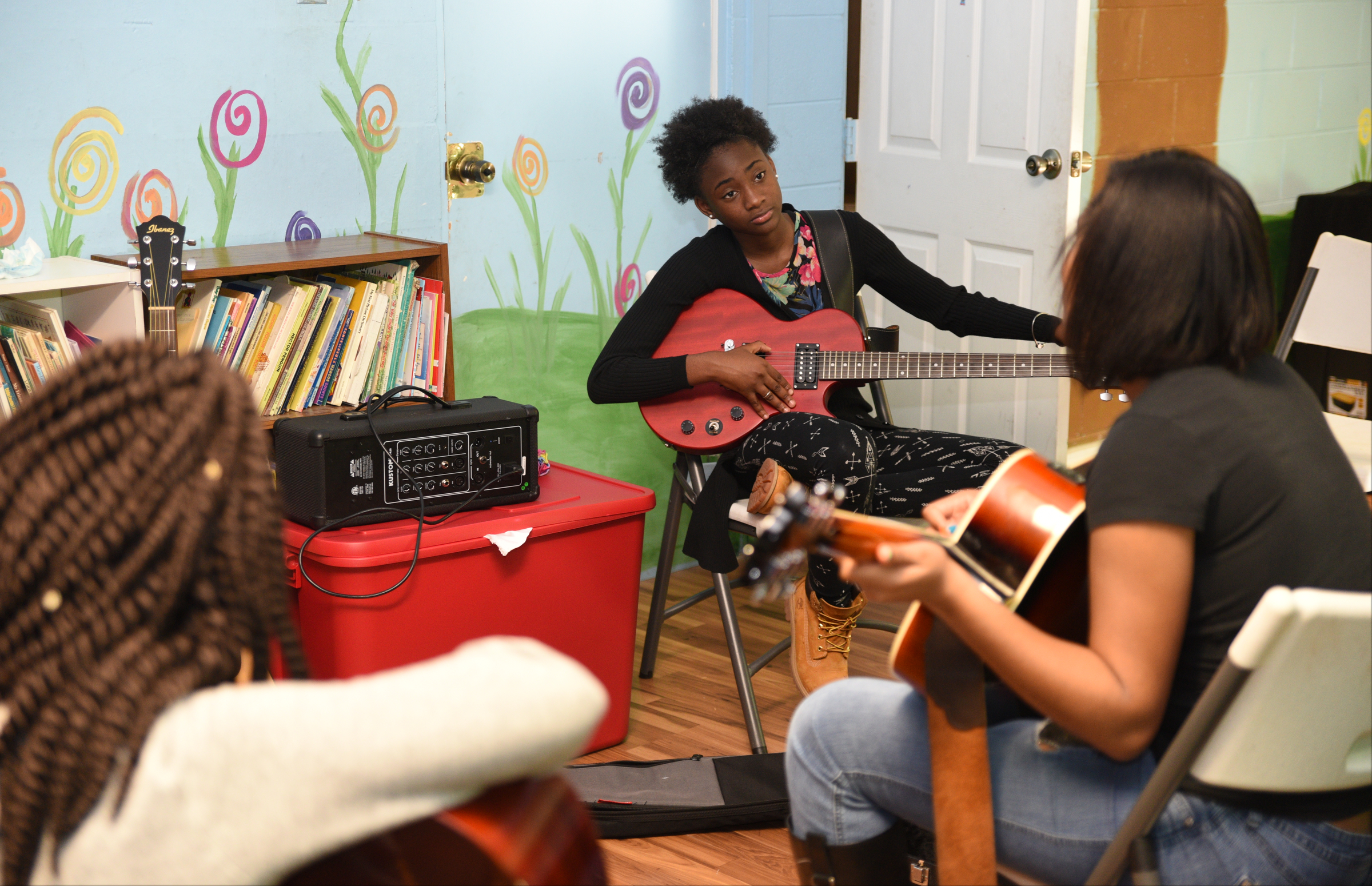 Kaylyn Yancey, center, tunes her guitar Wednesday, April 26, 2017 at Temple of Faith Deliverance Church.