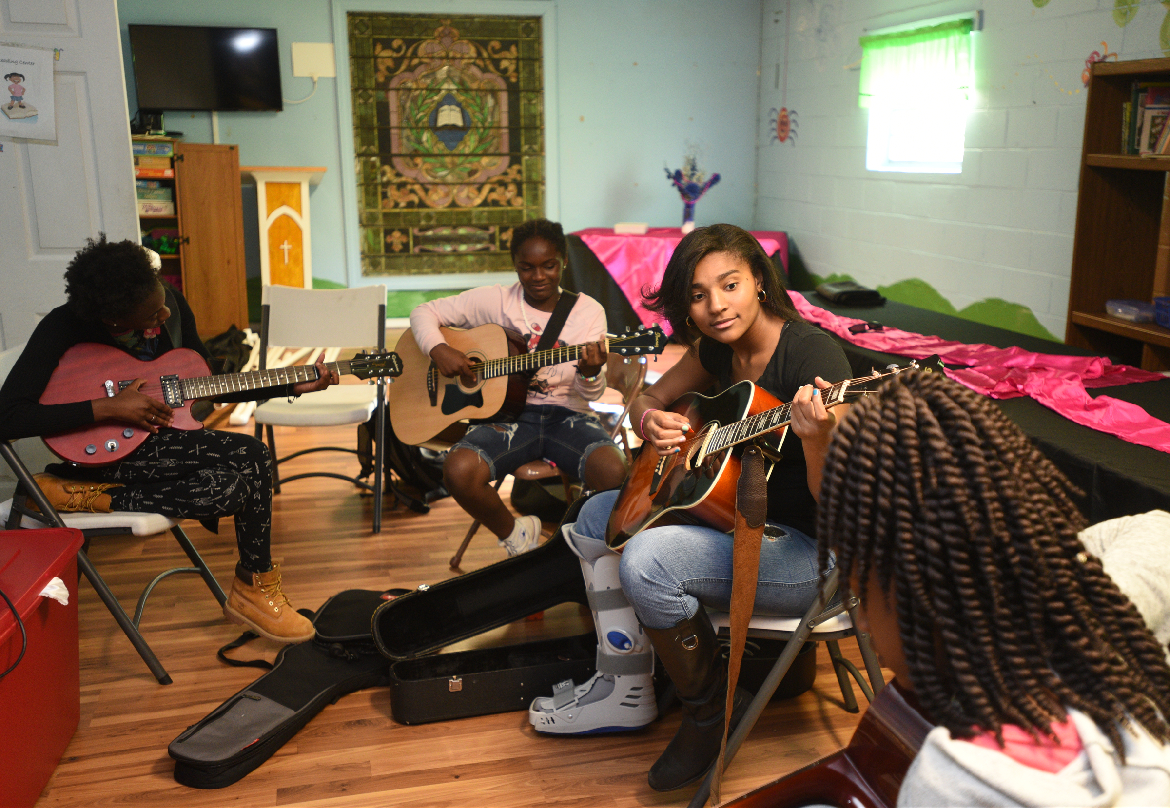 Kaylyn Yancey, Cheyenne Frye, Taylor Slack and Amari Sims, from left, play music Wednesday, April 26, 2017 at Temple of Faith Deliverance Church.