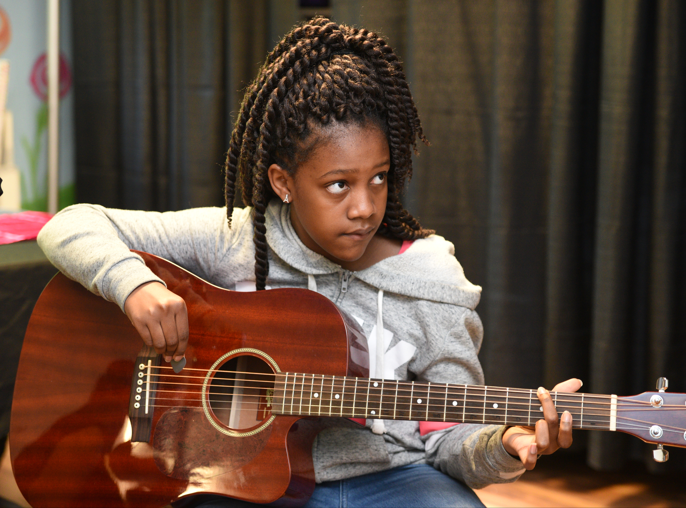 Amari Sims tunes her guitar Wednesday, April 26, 2017 at Temple of Faith Deliverance Church.