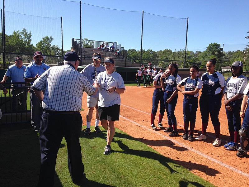 Larry Bateman presents the Terry Cordell Memorial Softball Sportsmanship Award to CSAS coach Michelle Meyners and her team before Tuesday's game at Silverdale Baptist Academy.