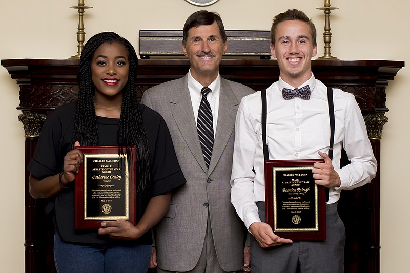 Dr. Paul Conn, president of Lee University, stands between the 2016-17 winners of the school's student-athlete award named for him, volleyball player Catherine Conley and runner Brandon Raleigh.