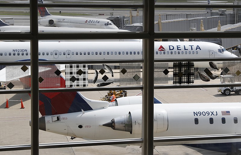 
              FILE - In this Monday, Aug. 8, 2016, file photo, Delta Air Lines planes are parked at Ronald Reagan Washington National Airport, in Washington. A California family says they were forced off a Delta plane and threatened with jail after refusing to give up one of their children's seats on a crowded flight. A video of the April 23, 2017, incident was uploaded to Facebook on Wednesday, May 3, 2017, and adds to the list of recent encounters on airlines that went viral, including the dragging of a passenger off a United Express plane. (AP Photo/Carolyn Kaster, File)
            