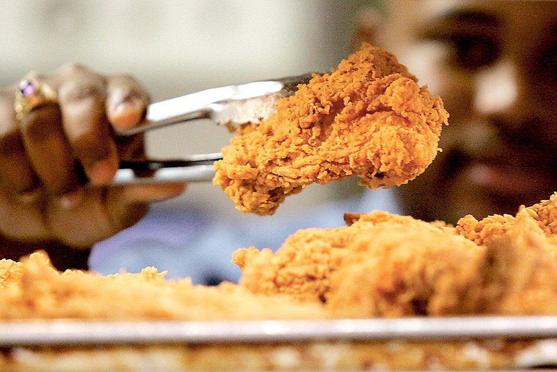 A cook serves up a piece of fried chicken. Tennessee cities eat quite unhealthily compared to the rest of country, according to a Gallup-Sharecare survey, which includes rankings for Chattanooga, Kingsport, Clarksville, Greater Nashville, Memphis and Knoxville.