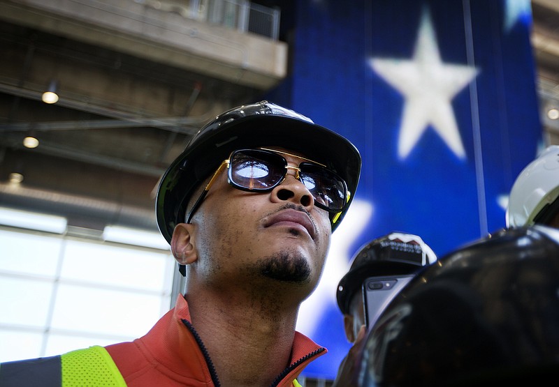 
              In this Tuesday, April 25, 2017, photo, rapper T.I. tours the Mercedes Benz Stadium, the new stadium for the Atlanta Falcons NFL football team under construction in Atlanta. In a recent interview, The Associated Press spoke with T.I. about his social justice efforts and upcoming music. (AP Photo/David Goldman)
            