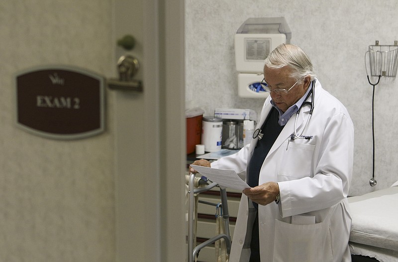 Dr. Robert Bowers visits a patient at Volunteers In Medicine.