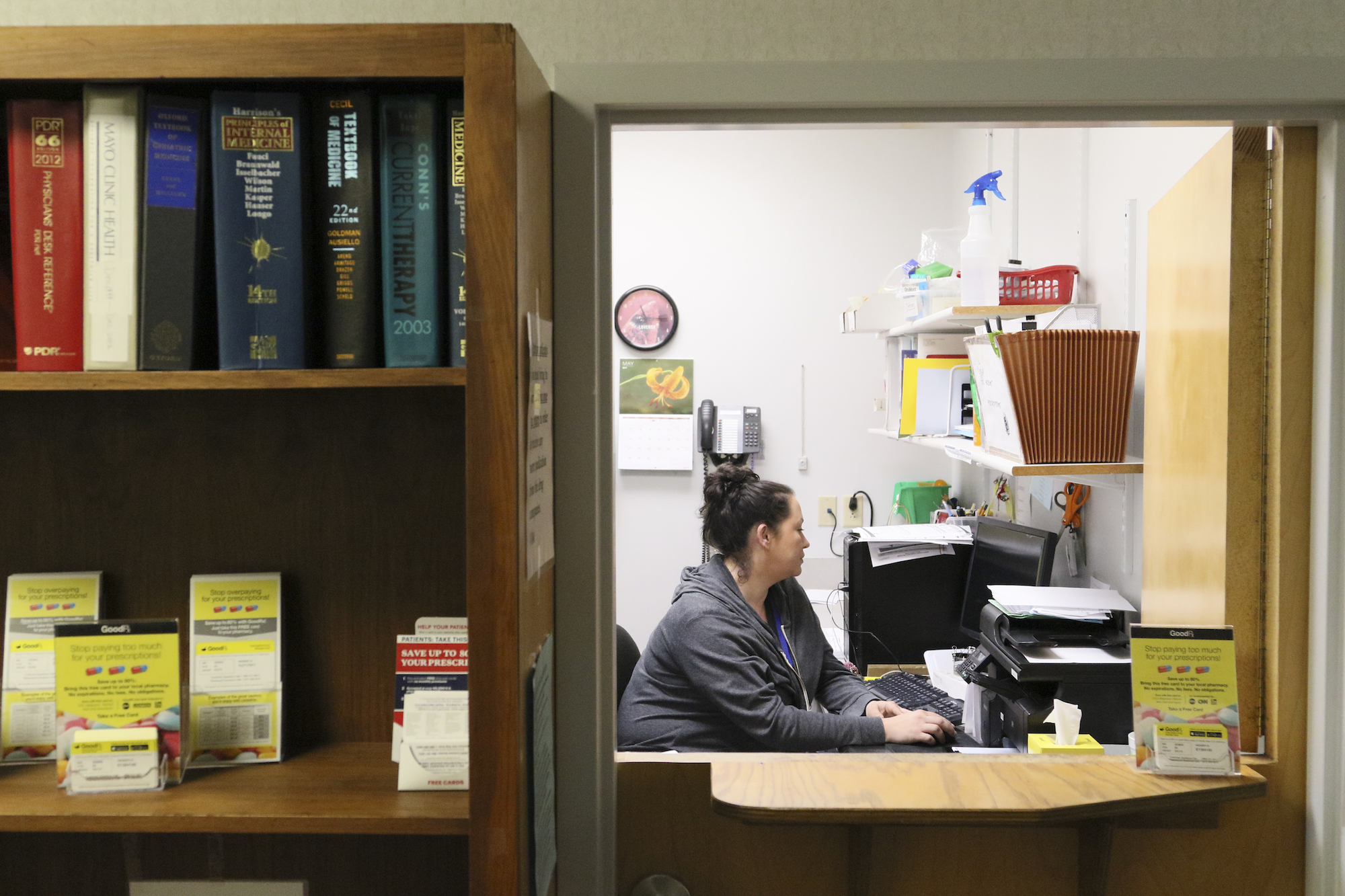 Kristen Curtis-Gortney, the back office coordinator, works on her case files at Volunteers In Medicine.