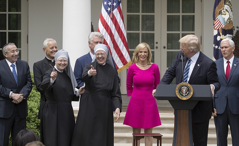 Nuns with the Little Sisters of the Poor give a thumbs up at a National Day of Prayer event with President Donald Trump and other religious leaders in the Rose Garden at the White House, in Washington, May 4, 2017. At the event Trump signed an executive order aimed at easing restrictions on political activity by tax-exempt churches and charities. (Stephen Crowley/The New York Times)