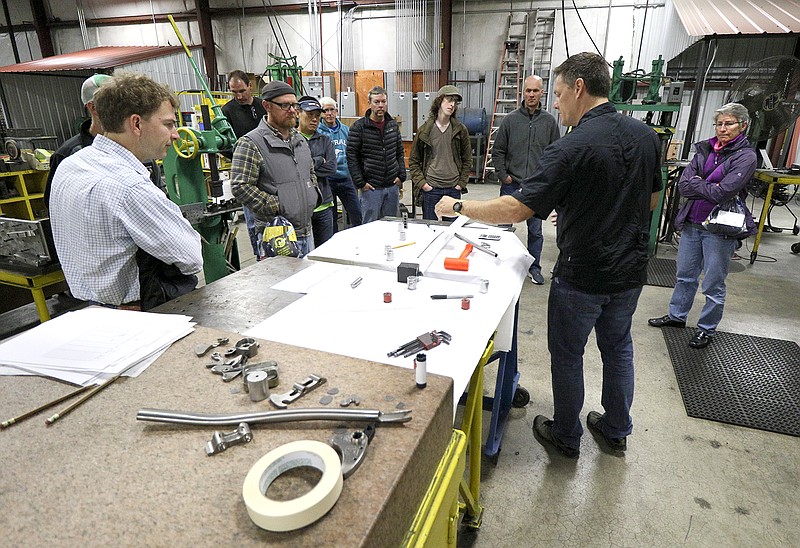 Staff Photo by Dan Henry / The Chattanooga Times Free Press- 5/5/17. Brad DeVaney leads a tour for Three State Three Mountain cycling event participants describing what goes into hand building titanium bicycle frames while at the Litespeed facility on May 5, 2017.