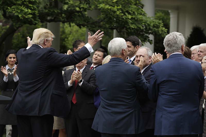 President Donald Trump acknowledges House Speaker Paul Ryan of Wis., in the Rose Garden of the White House in Washington, Thursday, May 4, 2017, after the House pushed through a health care bill. (AP Photo/Evan Vucci)