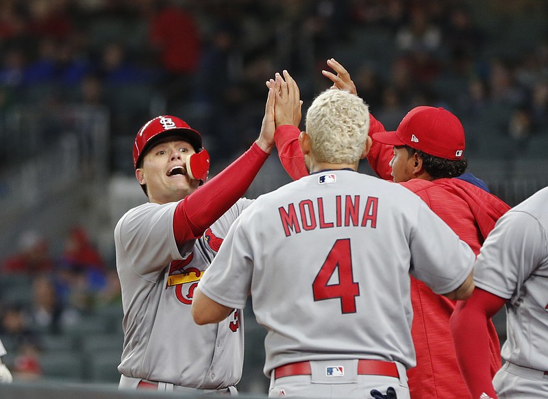 St. Louis Cardinals' Aledmys Diaz, left, celebrates at the dugout entrance after scoring on a two-run homer by Tommy Pham in the third inning of a baseball game against the Atlanta Braves Friday, May 5, 2017, in Atlanta. (AP Photo/John Bazemore)