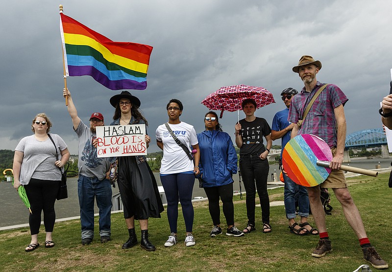 Demonstrators gather to a protest of a state bill that opponents say could harm the state's LGBT community held at Ross's Landing on Saturday, May 6, 2017, in Chattanooga, Tenn. About 20 attended the demonstration, which also protested a religious liberty executive order by President Donald Trump.