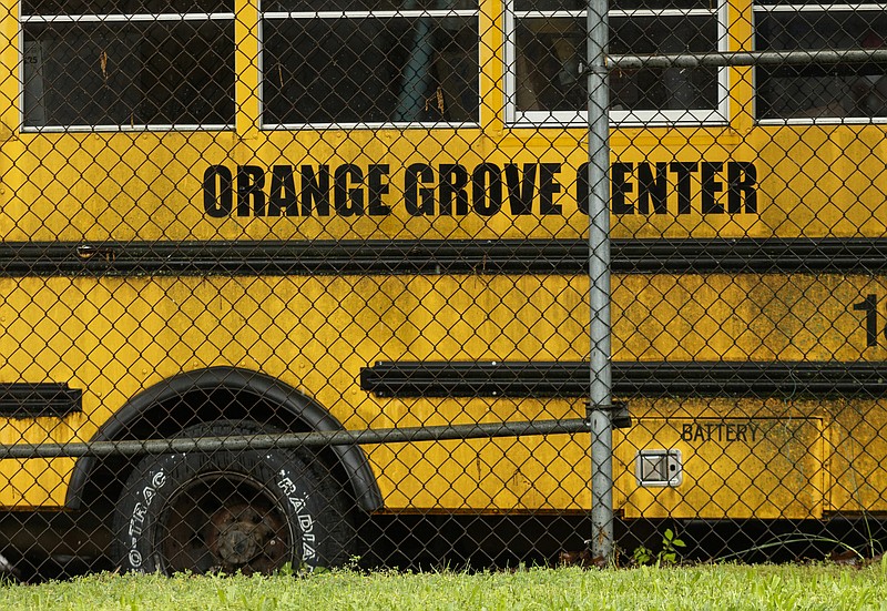 A school bus is parked in the Orange Grove Center bus lot on Thursday, May 4, 2017, in Chattanooga, Tenn. The center has had numerous complaints about patient care, and a client was found dead on a different Orange Grove bus last month.
