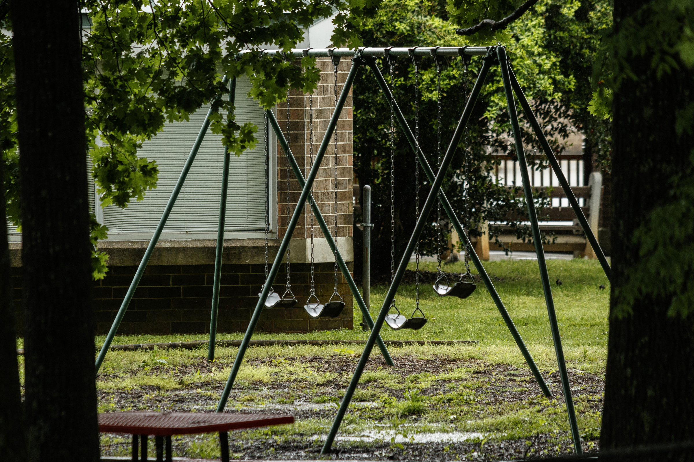 A swingset is seen on the campus of Orange Grove Center on Thursday, May 4, 2017, in Chattanooga, Tenn. The center has had numerous complaints about patient care, and a client was found dead on an Orange Grove bus last month.