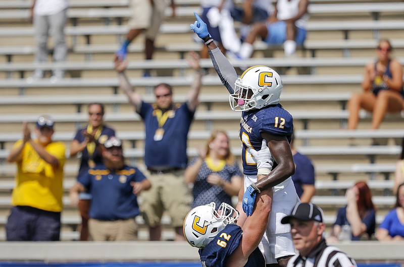 UTC offensive lineman Corey Levin (62) lifts teammate Xavier Borishade after Borishade's touchdown during the Mocs' home football game against Presbyterian at Finley Stadium on Saturday, Sept. 10, 2016, in Chattanooga, Tenn.