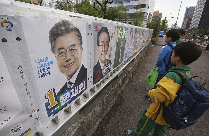 
              FILE - In this Thursday, April 20, 2017 file photo, elementary school children look at posters of candidates for the May 9 presidential election in Seoul, South Korea. Creating jobs, ending corruption and boosting low birthrates should be high on a to-do list for South Korea’s next president after a campaign mostly dominated by security and foreign policy issues. There is concern that the economy will likely take a backseat to North Korea when South Koreans pick their next leader on Tuesday. (AP Photo/Ahn Young-joon, File)
            