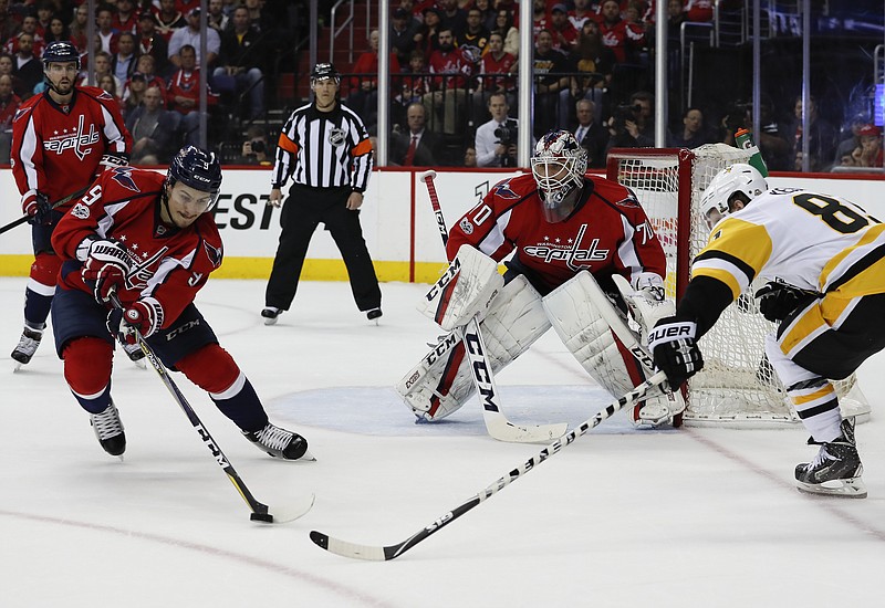 Washington Capitals defenseman Dmitry Orlov (9), from Russia, goalie Braden Holtby (70), defend as Pittsburgh Penguins right wing Phil Kessel (81) moves in during the first period of Game 5 in the second-round of the NHL hockey Stanley Cup playoffs, Saturday, May 6, 2017, in Washington. (AP Photo/Carolyn Kaster)