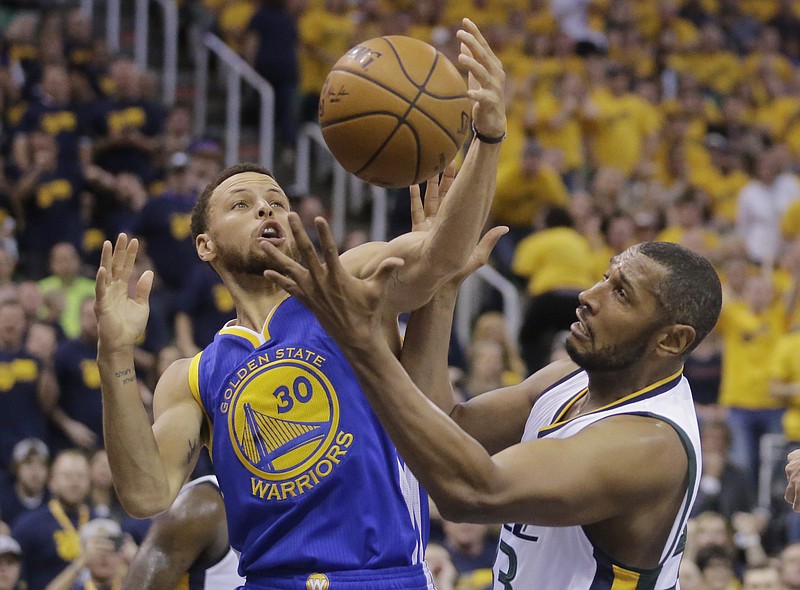 
              Golden State Warriors guard Stephen Curry (30) and Utah Jazz center Boris Diaw, right, battle for a rebound in the first half during Game 3 of the NBA basketball second-round playoff series Saturday, May 6, 2017, in Salt Lake City. (AP Photo/Rick Bowmer)
            