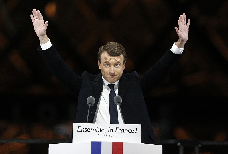 French President-elect Emmanuel Macron gestures during a victory celebration outside the Louvre museum in Paris, France, Sunday, May 7, 2017. Speaking to thousands of supporters from the Louvre Museum's courtyard, Macron said that France is facing an "immense task" to rebuild European unity, fix the economy and ensure security against extremist threats. (AP Photo/Thibault Camus)