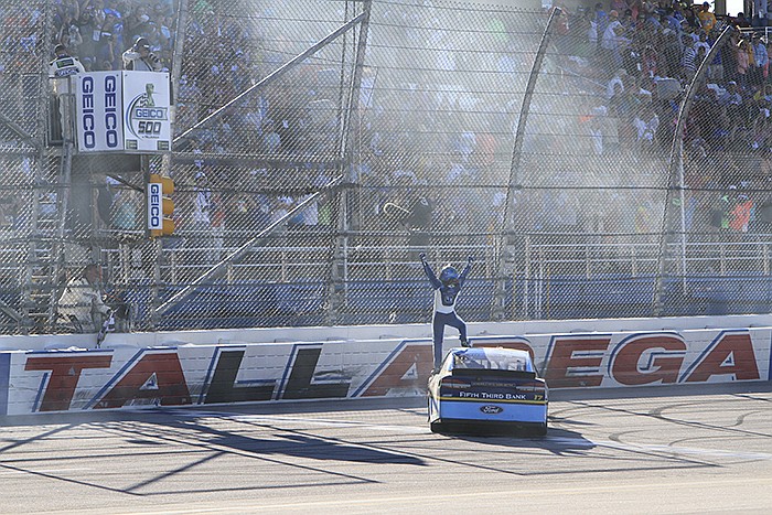 Ricky Stenhouse Jr. (17) celebrates at the start finish line after winning the Camping World 500 auto race at Talladega Superspeedway, Sunday, May 7, 2017, in Talladega, Ala. (AP Photo/Ron Sanders)