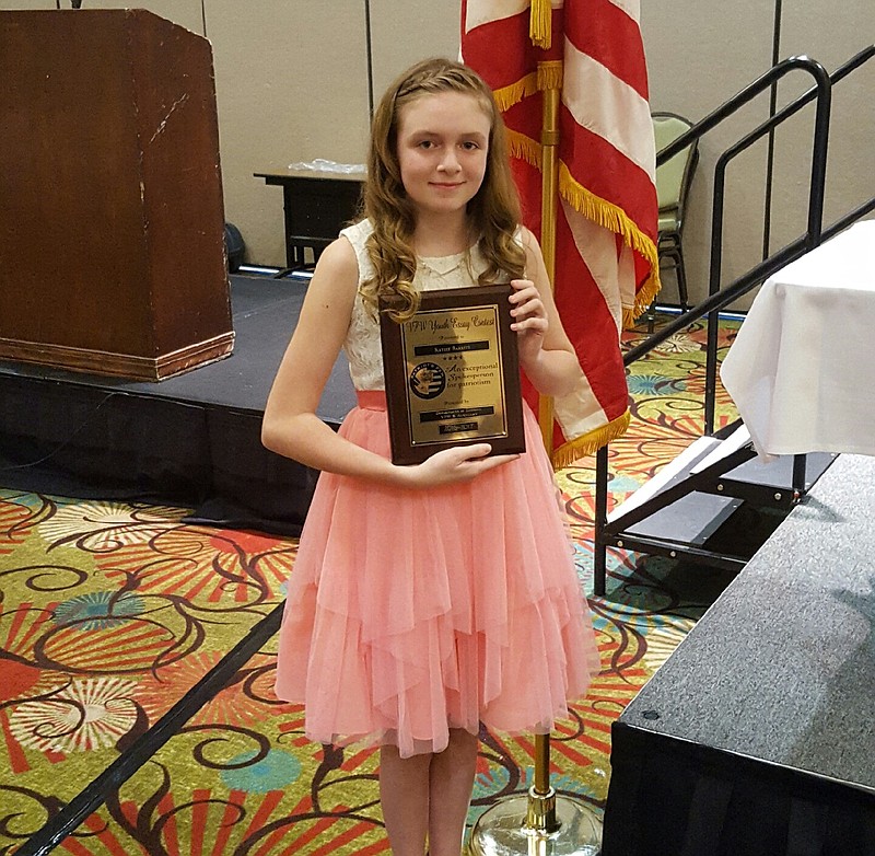 Chattanooga Valley Middle School seventh-grader Kaylee Barrett stands with a plaque she received for winning the Georgia VFW Patriot's Pen youth essay contest for those in grades 6-8.