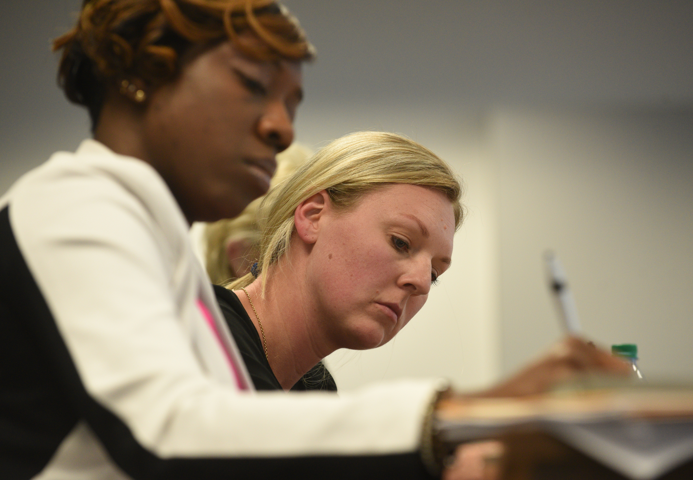 School board members Karitsa Mosley Jones, left, and Tiffanie Robinson take notes as superintendent candidate Stuart Greenberg speaks Monday, May 8, 2017 in the superintendent's conference room.