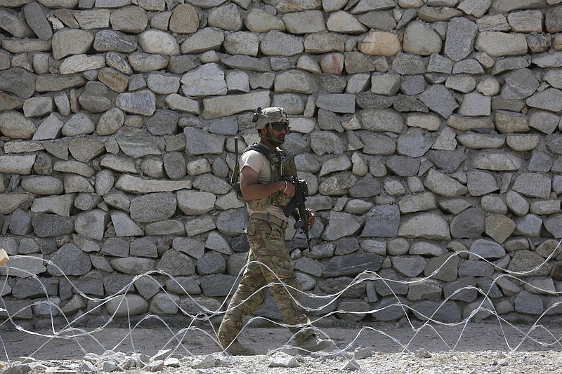 
              FILE - In this April 17, 2017, file photo, a U.S. soldier patrols in Asad Khil village near the site of a U.S. bombing in the Achin district of Jalalabad, east of Kabul, Afghanistan. As the administration of President Donald Trump weighs sending more troops to Afghanistan, the 16-year war grinds on in bloody stalemate. Afghan soldiers are suffering what Pentagon auditors call “shockingly high” battlefield casualties, and prospects are narrowing for a negotiated peace settlement with the Taliban.  (AP Photo/Rahmat Gul, File)
            