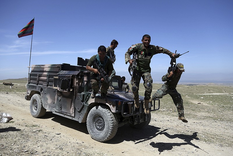 
              FILE - In this April 14, 2017, file photo, Afghan commandos arrive at Pandola village near the site of a U.S. bombing in the Achin district of Jalalabad, east of Kabul, Afghanistan. As the administration of President Donald Trump weighs sending more troops to Afghanistan, the 16-year war grinds on in bloody stalemate. Afghan soldiers are suffering what Pentagon auditors call “shockingly high” battlefield casualties, and prospects are narrowing for a negotiated peace settlement with the Taliban. (AP Photo/Rahmat Gul, File)
            