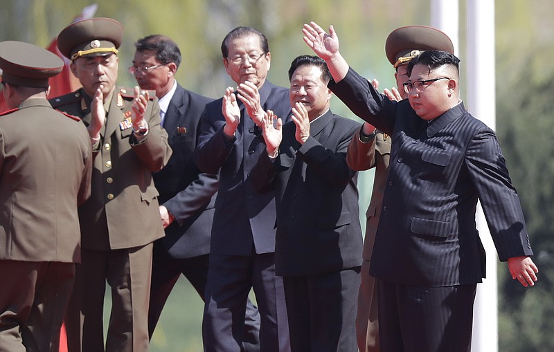 In this April 13, 2017 photo, North Korean leader Kim Jong Un, right, waves during the opening ceremony of the Ryomyong residential area, a collection of more than a dozen apartment buildings in Pyongyang, North Korea. While the South prepares for its presidential election, some major and mysterious intrigue has been brewing over the past week in North Korea, including announcements that two American university instructors had been arrested and claims of a CIA-backed plot to assassinate Kim with some sort of biochemical poison. (AP Photo/Wong Maye-E)

