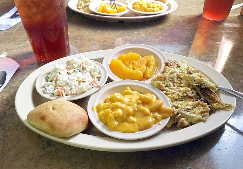 Farmhouse's chicken casserole special with sides of macaroni and cheese, peaches, coleslaw, roll and sweet tea.