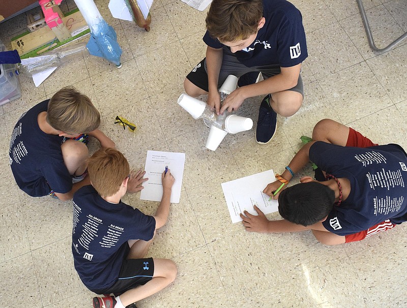 From left, Thrasher Elementary students Jake Edmundson, Milo Newton, Ben Timblin, and Ty Harper review the performance of their rocket.  The regional Elementary Science Olympiad, sponsored by Tennessee American Water Company and TVA, was held on May 9, 2017 at Chattanooga State Community College.  
