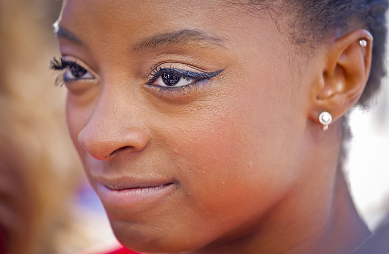 
              FILE - In this Aug. 23, 2016, file photo, U.S. Olympic gold medalist gymnast Simone Biles listens during an interview at the Empire State Building in New York. The Olympic champion gymnast stood tightlipped while receiving feedback from judge Carrie Ann Inaba following her performance on the Monday, May 8, 2017, edition of “Danciing with the Stars.” When host Tom Bergeron asked Biles why she didn’t smile while hearing some of the praise from Inaba, Biles grinned and said, “smiling doesn’t win you gold medals.” (AP Photo/Bebeto Matthews, File)
            