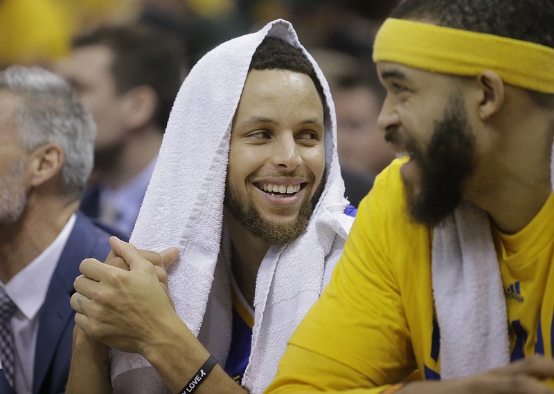 
              Golden State Warriors' Stephen Curry, left, and JaVale McGee (1) share a laugh as they sit on the bench at the end of the second half during Game 4 of the NBA basketball second-round playoff series against the Utah Jazz Monday, May 8, 2017, in Salt Lake City. The Warriors completed a second-round sweep of the Utah Jazz with a 121-95 victory. (AP Photo/Rick Bowmer)
            