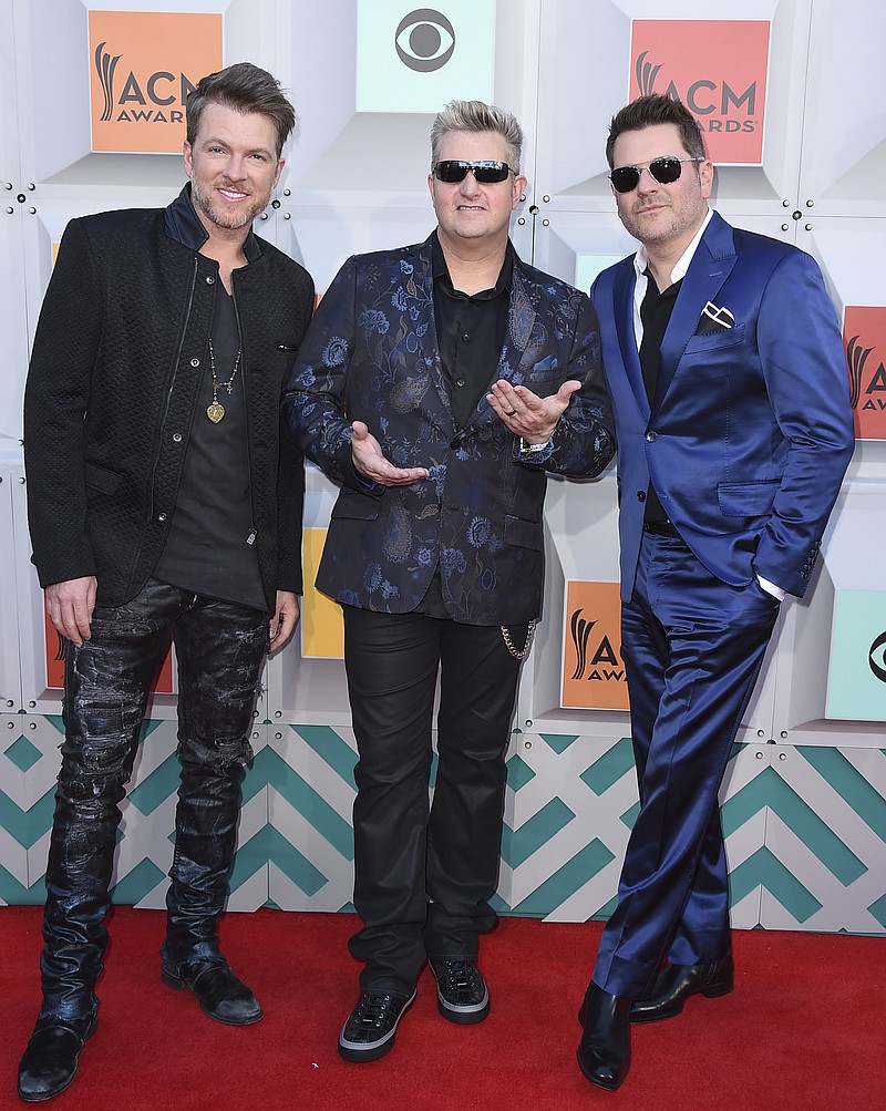 
              FILE - In this April 3, 2016, file photo, Joe Don Rooney, from left, Gary LeVox, and Jay DeMarcus, of Rascal Flatts, arrive at the 51st annual Academy of Country Music Awards in Las Vegas. On their 10th studio album, Rascal Flatts relies on young singers and songwriters to keep their music sounding fresh after 17 years together. The country trio has cut songs by pop singer/songwriter Meghan Trainor and new country duo Dan + Shay, and recorded a duet with “American Idol” alum Lauren Alaina.  (Photo by Jordan Strauss/Invision/AP, File)
            