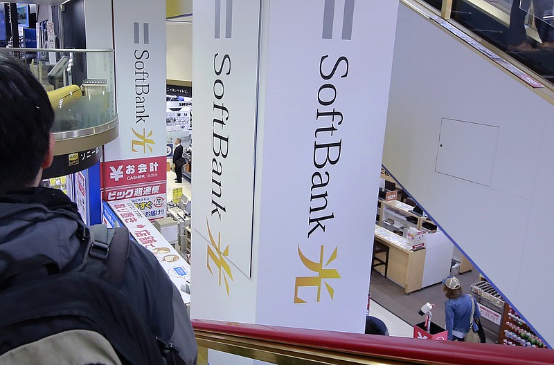 
              FILE - In this Nov. 7, 2016, file photo, a shopper standing on an escalator passes by the company logo of SoftBank at an electronic shop in Tokyo. Japanese internet, robot and solar company SoftBank Group is reporting a 12-fold climb in quarterly profit, boosted by a turnaround at its U.S. mobile unit Sprint, on its way to a record annual profit. Tokyo-based SoftBank reported Wednesday, May 10, 2017, January-March profit of 580.5 billion yen ($5.1 billion), up dramatically from 45.2 billion yen the same period the previous year. (AP Photo/Shizuo Kambayashi, File)
            