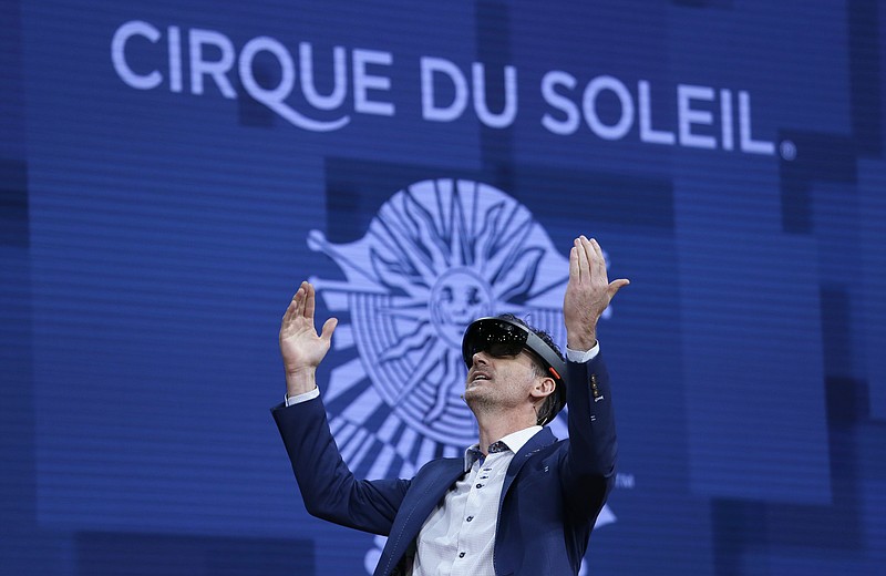 
              A member of Cirque du Soleil demonstrates use of Microsoft's HoloLens device in helping to virtually design a set at the Microsoft Build 2017 developers conference, Thursday, May 11, 2017, in Seattle. (AP Photo/Elaine Thompson)
            