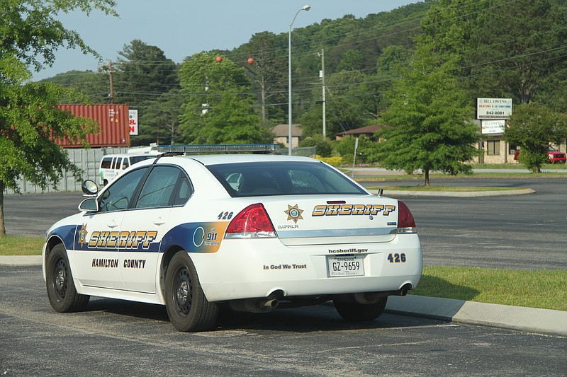A Hamilton County Sheriff's Office vehicle parked at the sheriff's annex on Dayton Boulevard bears an "In God we trust" sticker.

