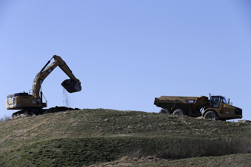 
              FILE - In this Jan. 14, 2016, file photo, coal ash is removed from the Dan River Steam Station in Eden, N.C., to be transported by rail to a permanent site in Virginia. A utilities group is asking the Environmental Protection Agency to sweep away rules governing the disposal of the poison-laden ash left behind when coal is burned to generate electricity. (AP Photo/Gerry Broome, File)
            