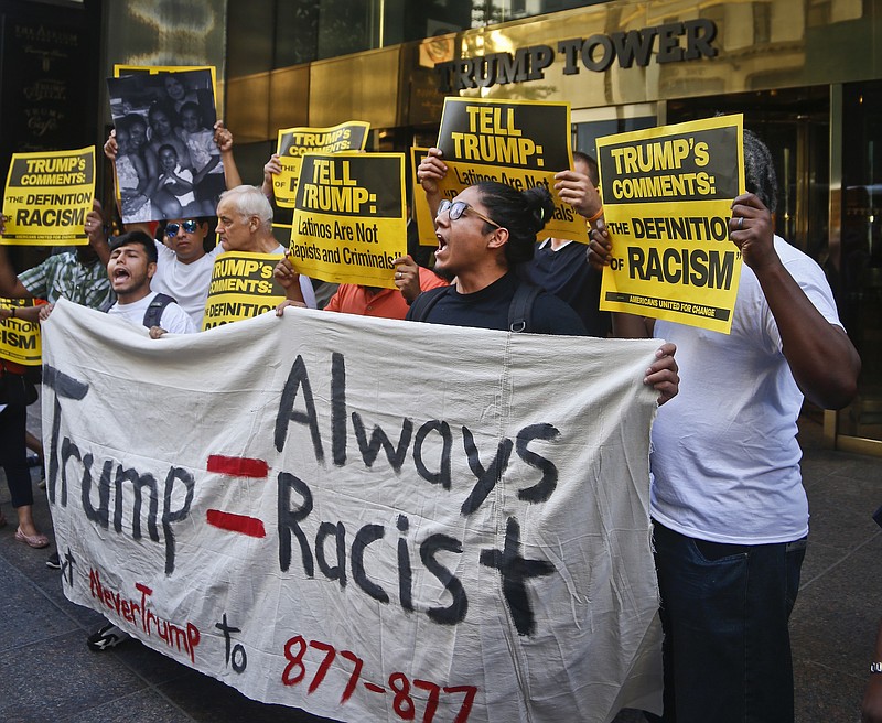 Anti-Trump protesters demonstrate outside a meeting between Donald Trump and minority Republicans at Trump Tower, Thursday Aug. 25, 2016, in New York. (AP Photo/Bebeto Matthews)