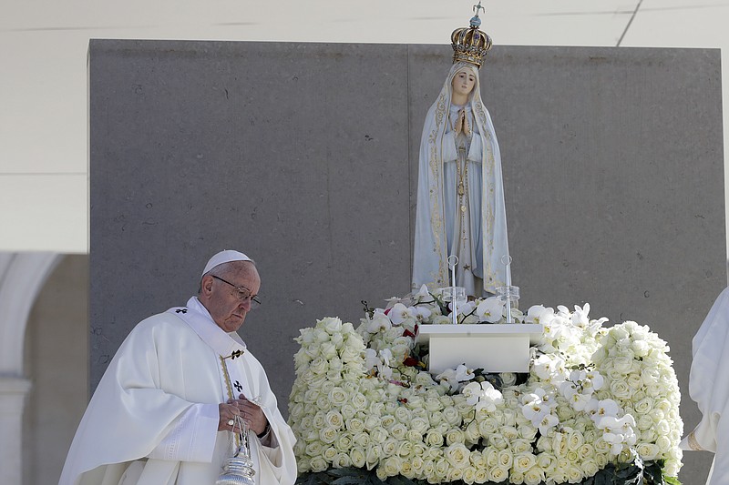 
              Pope Francis walks past a statue of the Virgin Mary prior to the start of a mass at the Sanctuary of Our Lady of Fatima Saturday, May 13, 2017, in Fatima, Portugal. The pontiff will canonize on Saturday two poor, illiterate shepherd children whose visions of the Virgin Mary 100 years ago marked one of the most important events of the 20th-century Catholic Church. (AP Photo/Alessandra Tarantino)
            