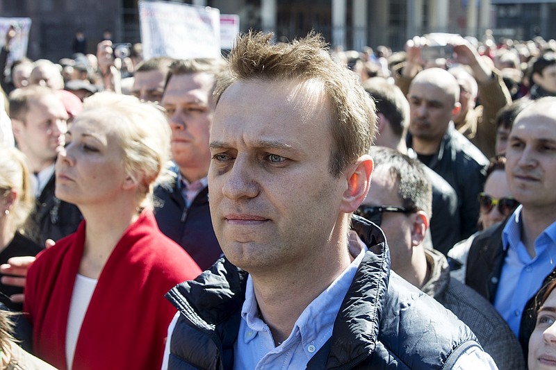 
              Russian opposition leader Alexei Navalny, center, takes part in a rally in Moscow, Russia, Sunday, May 14, 2017. More than 10,000 people have taken to the streets in Moscow to protest against a controversial plant to tear down Soviet-era low-rise apartment blocks. (AP Photo/Pavel Golovkin)
            