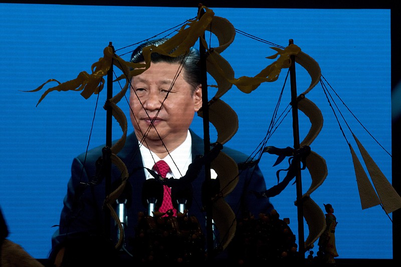 
              Chinese President Xi Jinping speaking at the opening of the Belt and Road Forum is displayed on a big screen near a decoration depicting Chinese Admiral Zheng He who commanded expeditionary voyages across Asia and East Africa in the 15th century in Beijing, China, Sunday, May 14, 2017. China will seek to burnish President Xi Jinping's stature as a world-class statesman at the international gathering centered on his signature foreign policy effort that envisions a future world order in which all roads lead to Beijing. (AP Photo/Ng Han Guan)
            