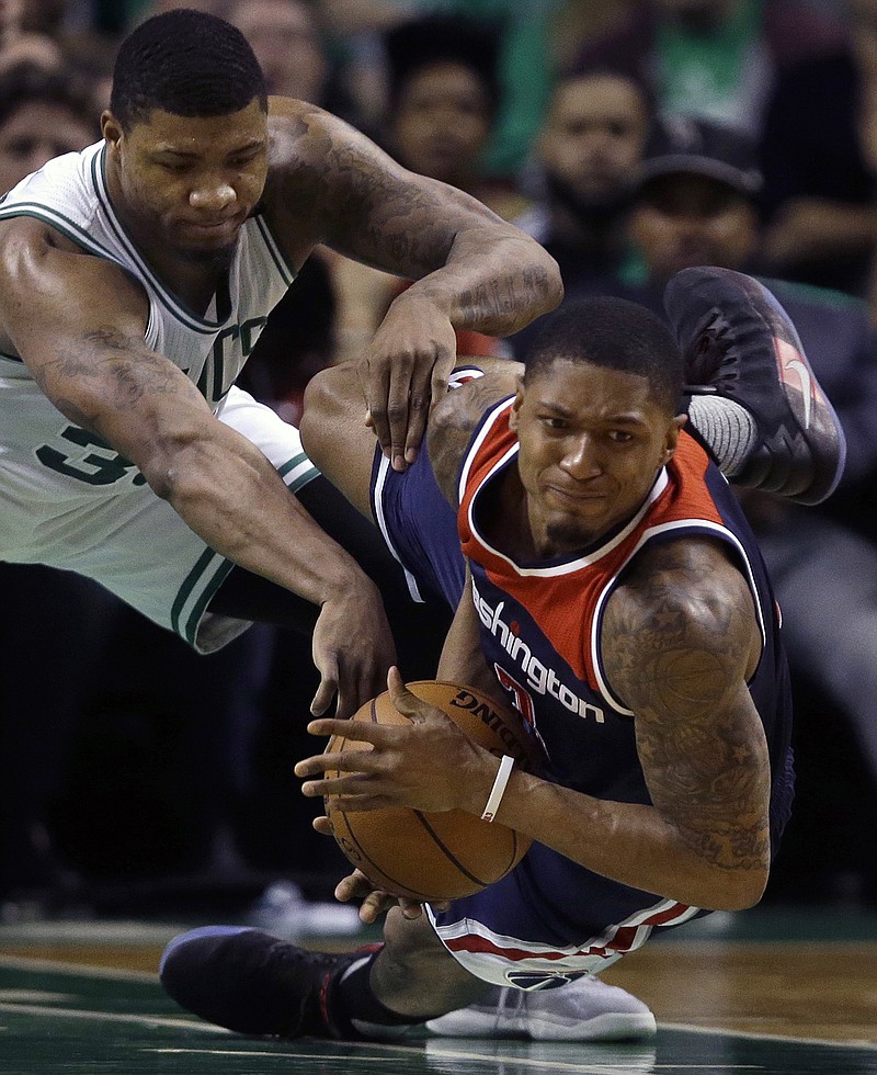 
              Washington Wizards guard Bradley Beal, right, goes down with the ball as Boston Celtics guard Marcus Smart defends during the second quarter of Game 7 of a second-round NBA basketball playoff series, Monday, May 15, 2017, in Boston. (AP Photo/Charles Krupa)
            