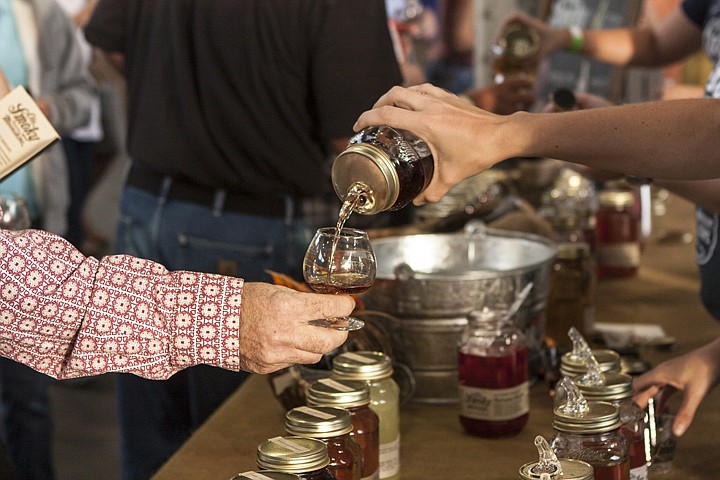 A guest gets a sample of Ole Smokey Moonshine at last year's festival. Ole Smokey Moonshine is returning for this year's festival in First Tennessee Pavilion.