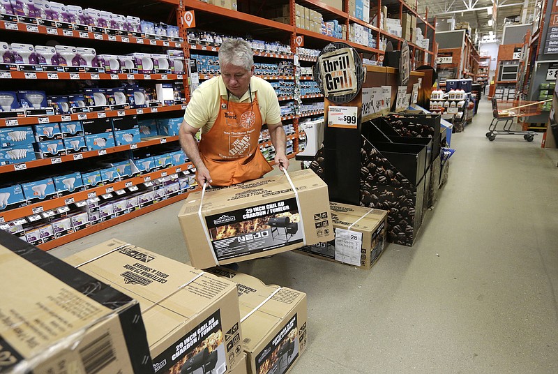 
              FILE - In this Wednesday, May 18, 2016, file photo, Home Depot supervisor David Petersen stacks barbecue smokers at a Home Depot store location, in Bellingham, Mass. The Home Depot Inc. reports earnings Tuesday, May 16, 2017.  (AP Photo/Steven Senne, File)
            