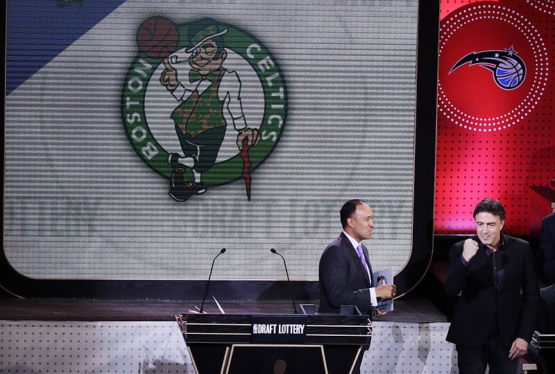 NBA Deputy Commissioner Mark Tatum, left, watches as Boston Celtics co-owner Wyc Grousbeck, right, reacts after the learning the Celtics had won the first pick in the NBA basketball draft, at the draft lottery Tuesday, May 16, 2017, in New York. (AP Photo/Frank Franklin II)