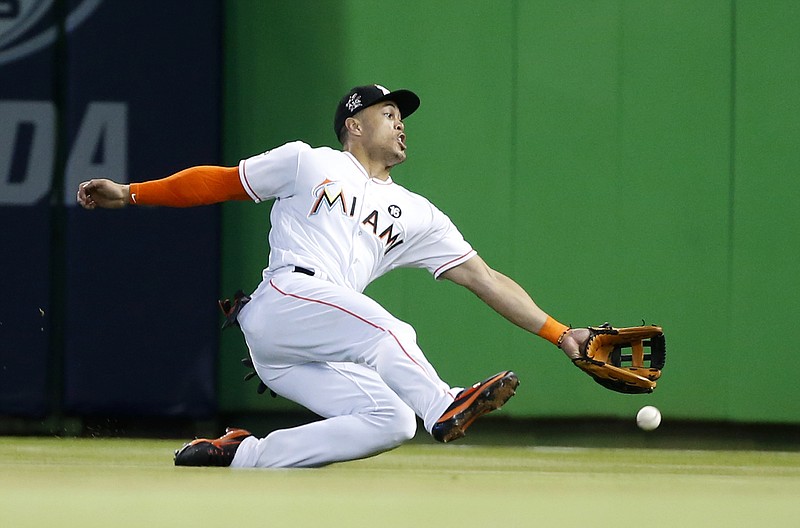 
              Miami Marlins right fielder Giancarlo Stanton is unable to catch a ball hit by Houston Astros' Jose Altuve for a double during the ninth inning of a baseball game, Wednesday, May 17, 2017, in Miami. The Astros defeated the Marlins 3-0. (AP Photo/Wilfredo Lee)
            